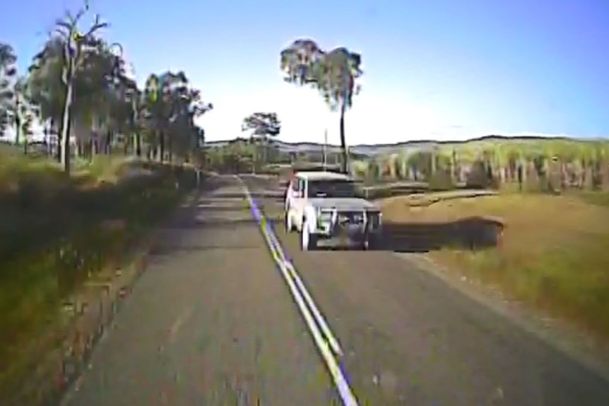 Dashcam footage of four-wheel drive on a country road.