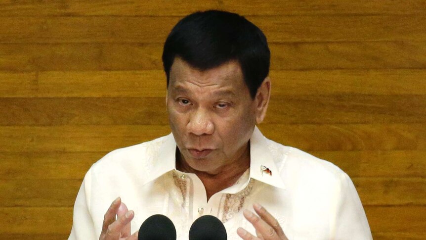Rodrigo Duterte speaks in front of a lectern