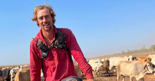 A man rides a bike with cattle behind him