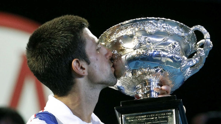 Novak Djokovic holds his trophy after winning the men's singles final match at the Australian Open tennis, 2011. (Reuters)