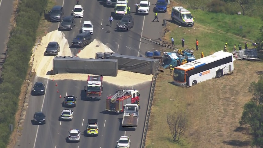 Traffic builds up in front of an overturned truck 