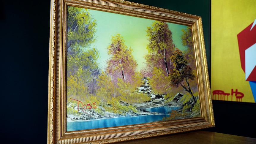 A framed painting of a river running through a landscape 
