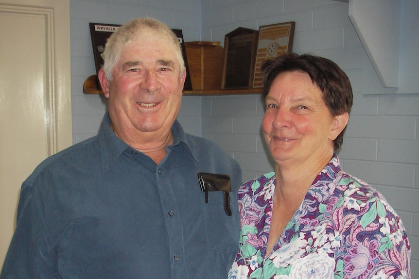 A close up of an elderly couple smiling