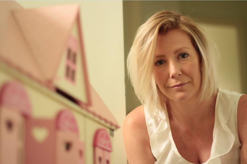 Sally Faulkner next to dollhouse