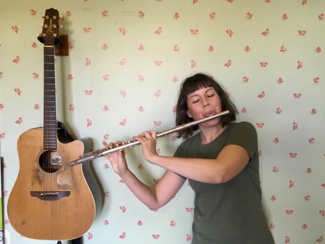 A woman playing a flute