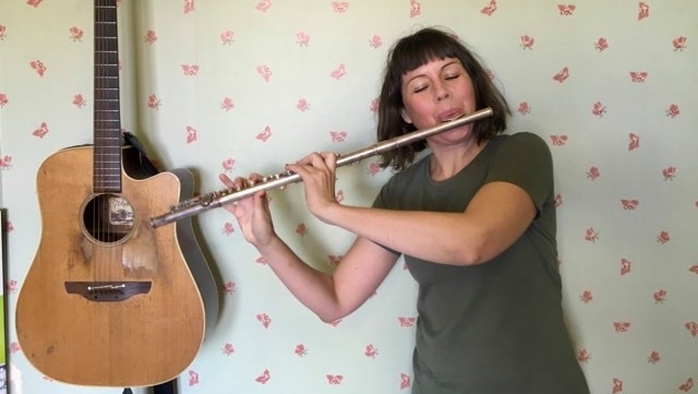 A woman playing a flute.