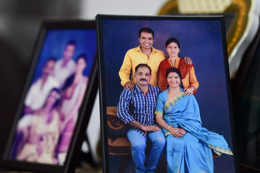 Family photos of Bindu's family in frames