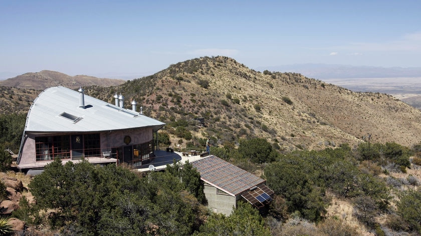 A home built by 'off-grid' pioneer, architect Todd Bogatay, sits on a hillside near Bisbee, Arizona, on May 14, 2008. Wind turbines power lights and appliances, while solar panels are used to heat water.