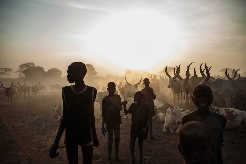 South Sudanese children from the Dinka ethnic group pose at cattle camp in the town of Yirol