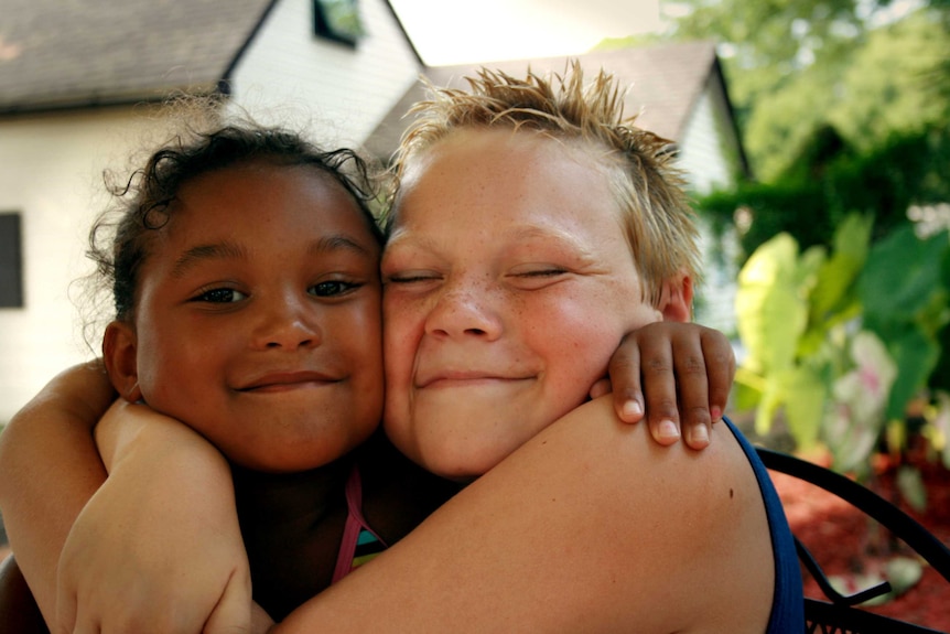 Children Alex and Ashley hugging.