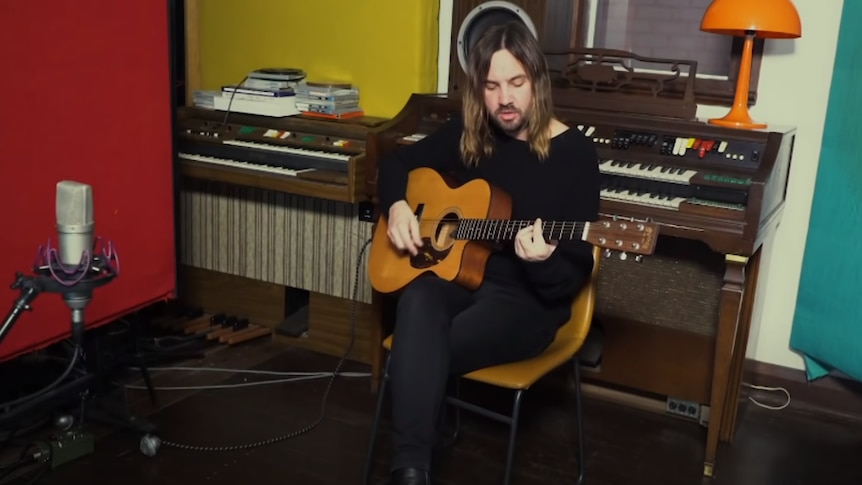 Image of Kevin Parker playing guitar in studio