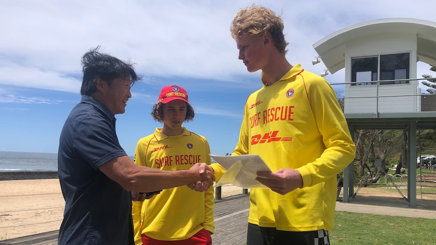 Andrew Bau meeting his rescuers for the first time at their local beach