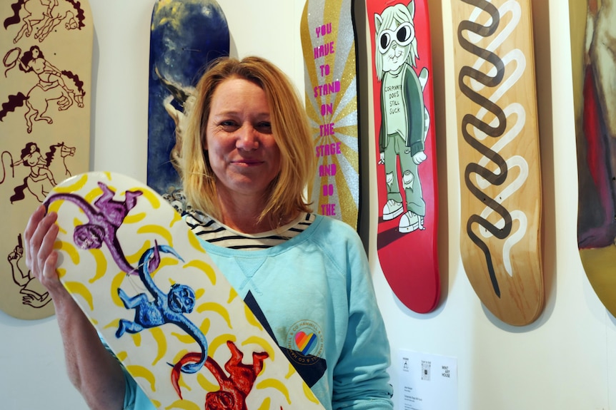 woman holding skateboard art