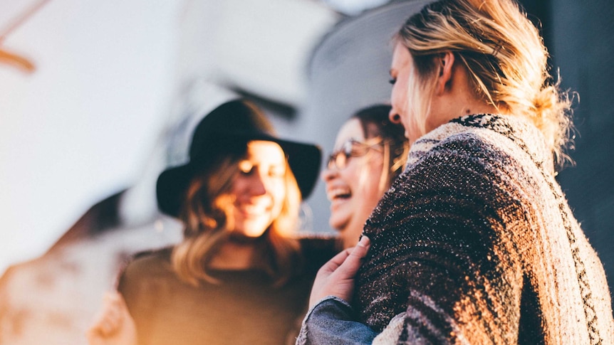 Group of women laughing and talking together for a story about people's changing relationship with alcohol.