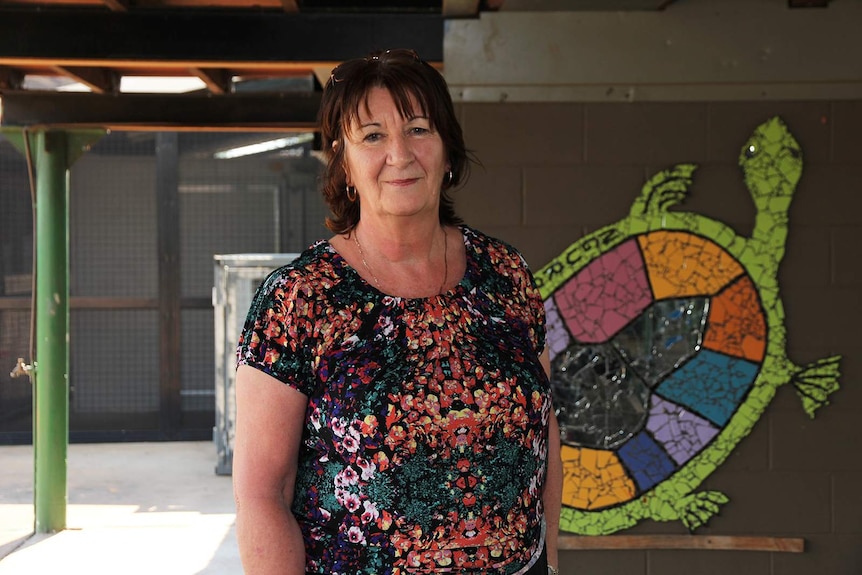 A photo of Gunbalanya Area School co-principal Sue Trimble before a school mural.