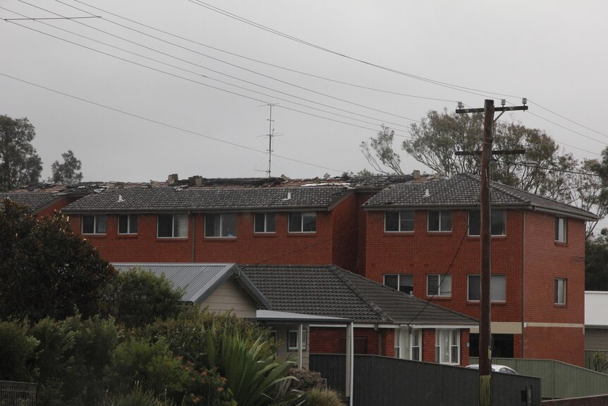 An apartment block with its roof ripped off. 