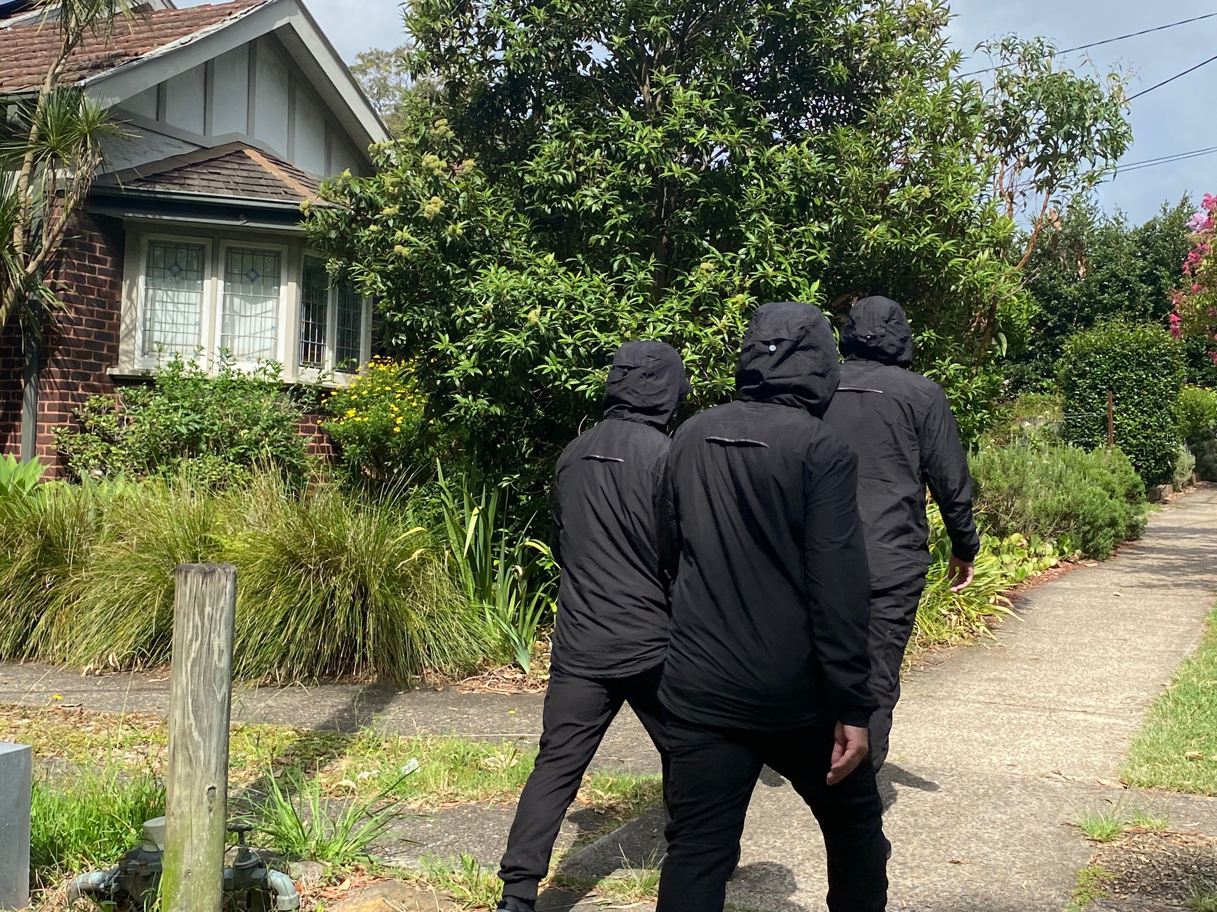 the back of men dressed in black suspected of being noe-nazis at Artarmon on 280124