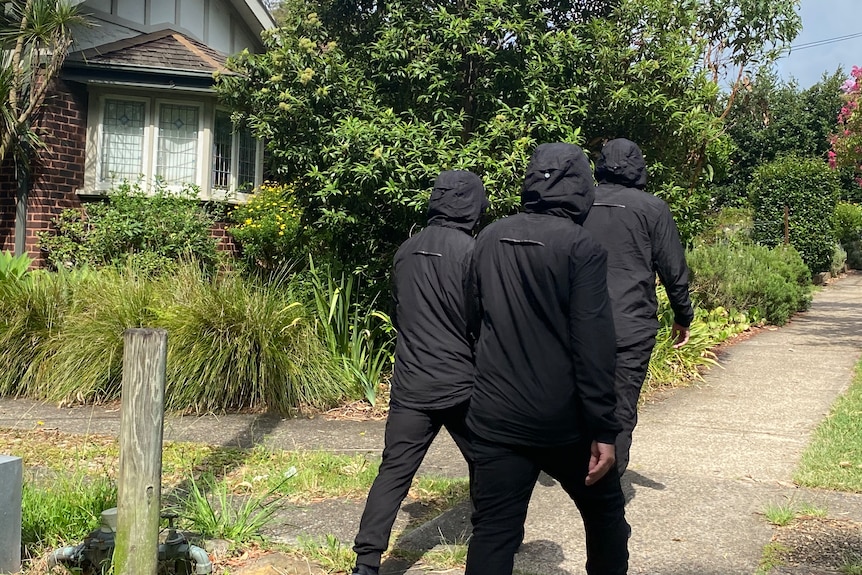 the back of men dressed in black suspected of being noe-nazis at Artarmon on 280124