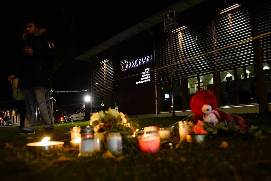 Flowers and candles have being left the scene of a primary and middle school in Trollhattan, southwestern Sweden
