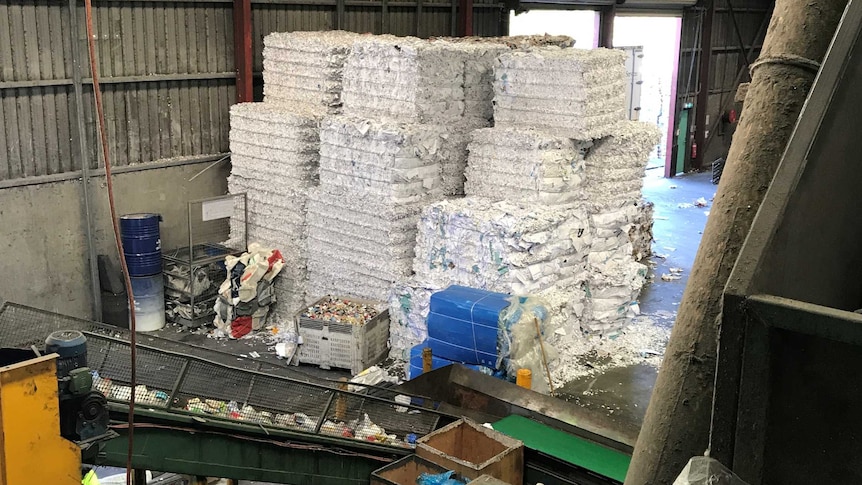 Stacked bales of paper at SKM Recycling in Derwent Park