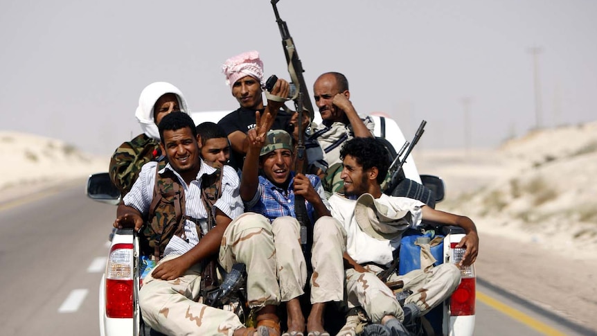 Libyan rebels ride on back of truck