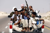 Libyan rebels ride on back of truck