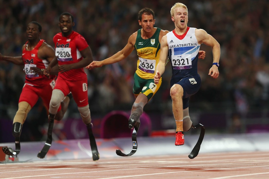 Britain's Jonnie Peacock (R) wins gold in men's T44 100m final at the London Paralympics.