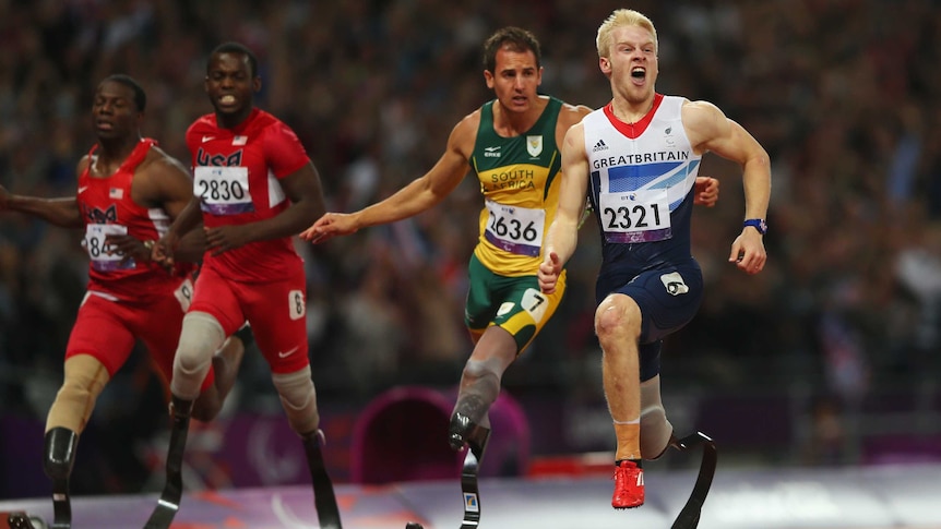 Britain's Jonnie Peacock (R) wins gold in men's T44 100m final at the London Paralympics.