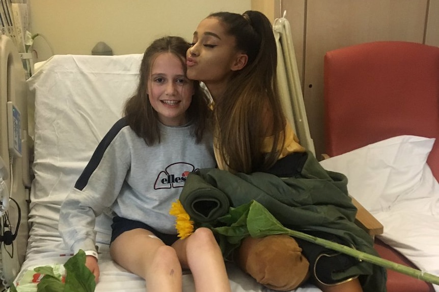 Ariana Grande poses with young fan Evie Mills at The Royal Manchester Children's Hospital.