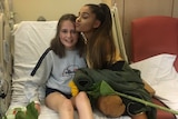 Ariana Grande poses with young fan Evie Mills at The Royal Manchester Children's Hospital.