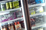 Alcopops sit in a bottle shop fridge