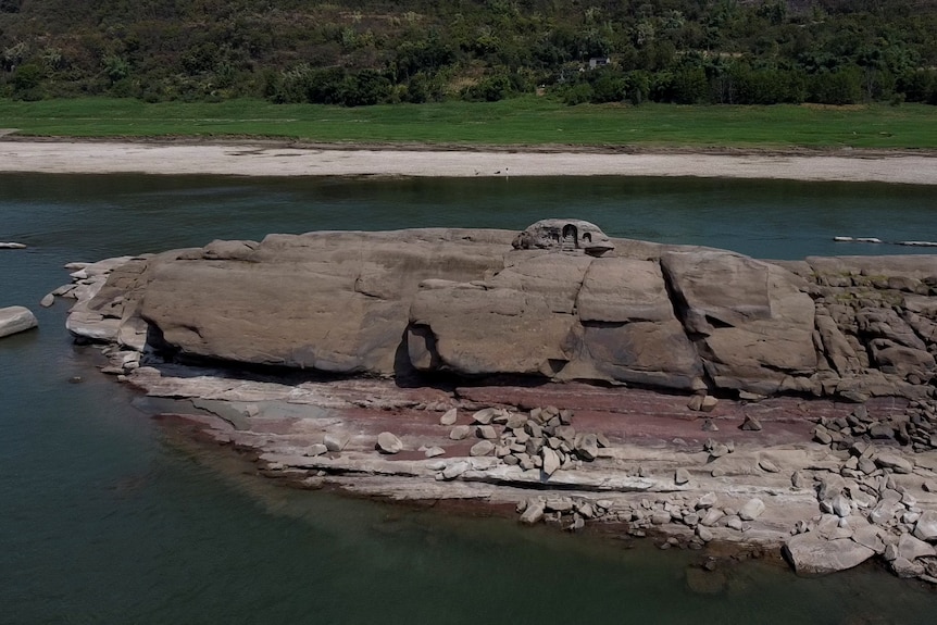 A once submerged Buddhist statue sits on top of Foyeliang island reef in the Yangtze River