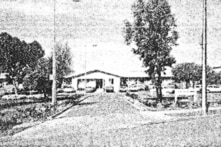 a black and white street view photo of a residential building 