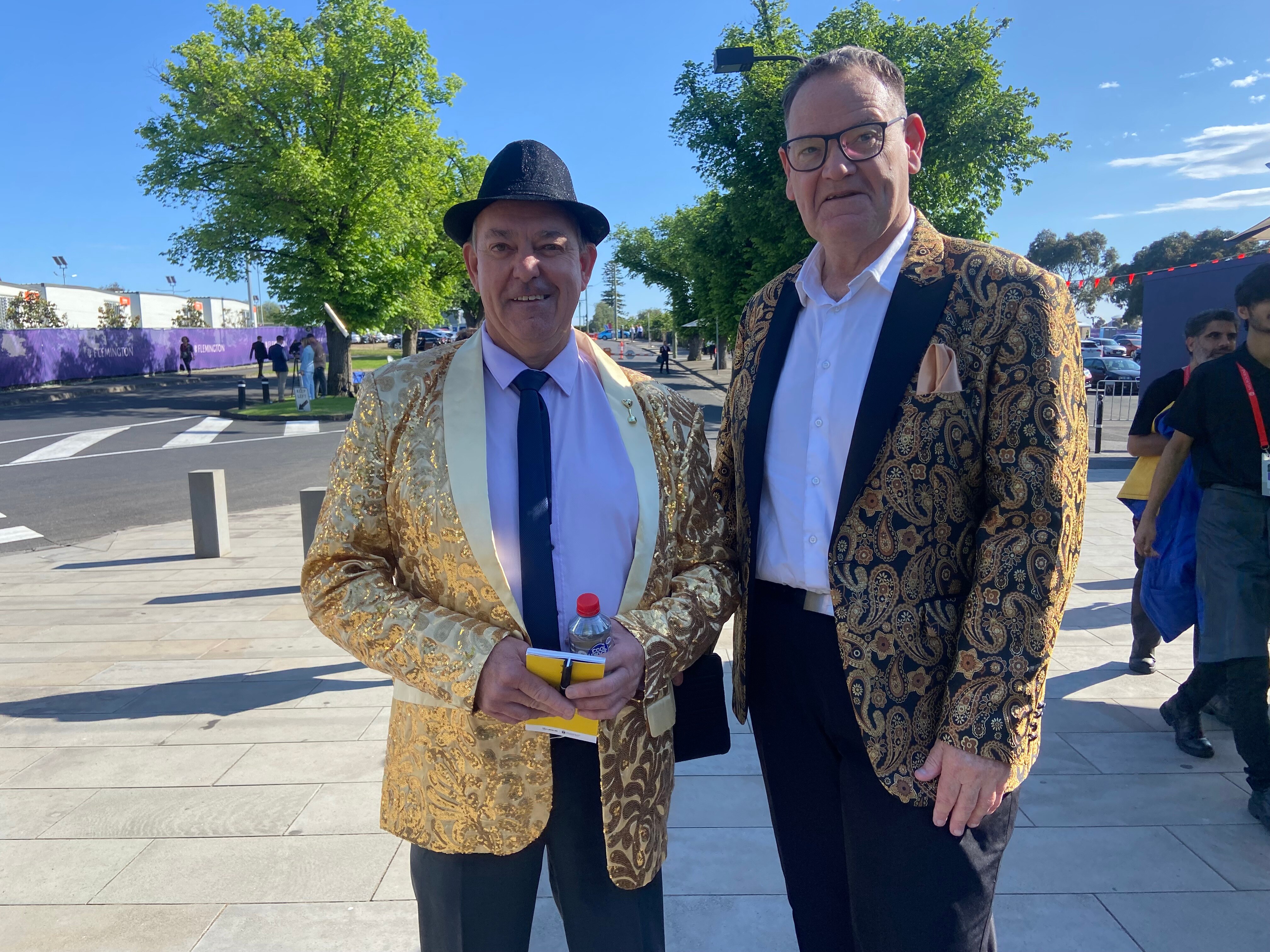 Two men in gold jackets