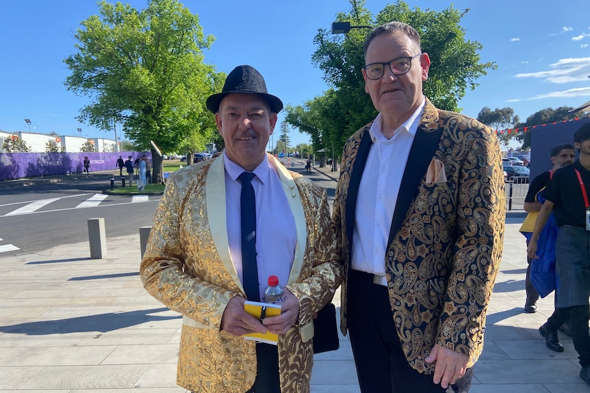 Two men in gold jackets