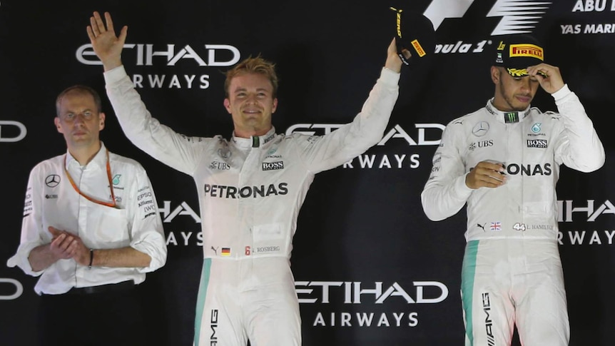 On top of the world ... Nico Rosberg (L) celebrates in Abu Dhabi, as Mercedes team-mates Lewis Hamilton looks on