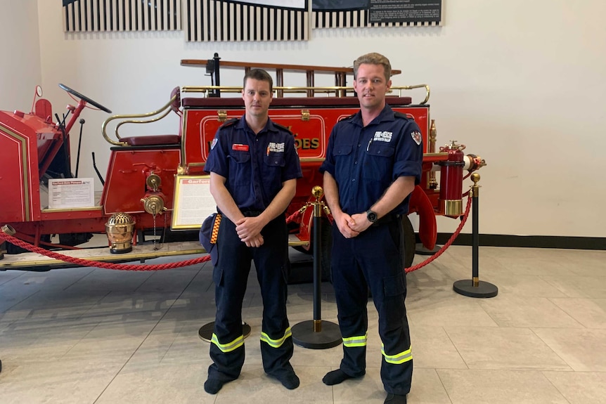 Deputy captain Jasper Croft and Kayle Barton pose for a photo in front of an old fashioned fire truck.