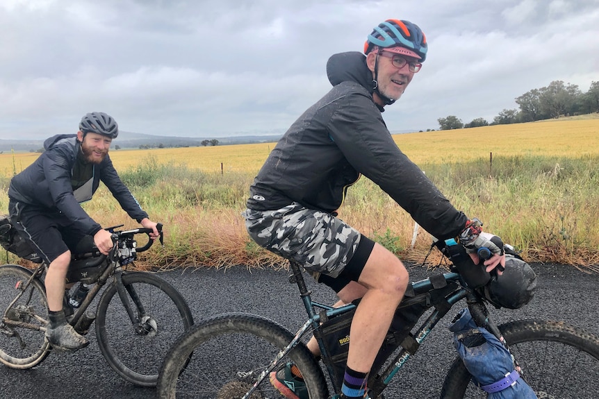 Two men on their bikes.