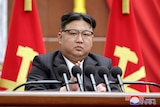 A close up of North Korean leader Kim Jong Un giving a speech.