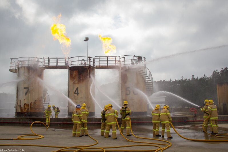Firefighters hose down a burning silo