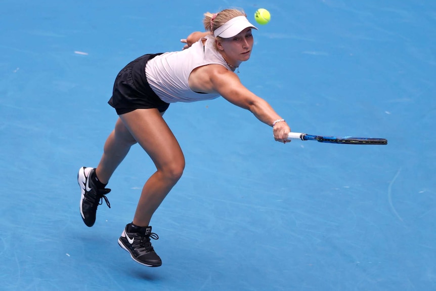 Daria Gavrilova reaches out to make a backhand return to Ash Barty at Melbourne Park