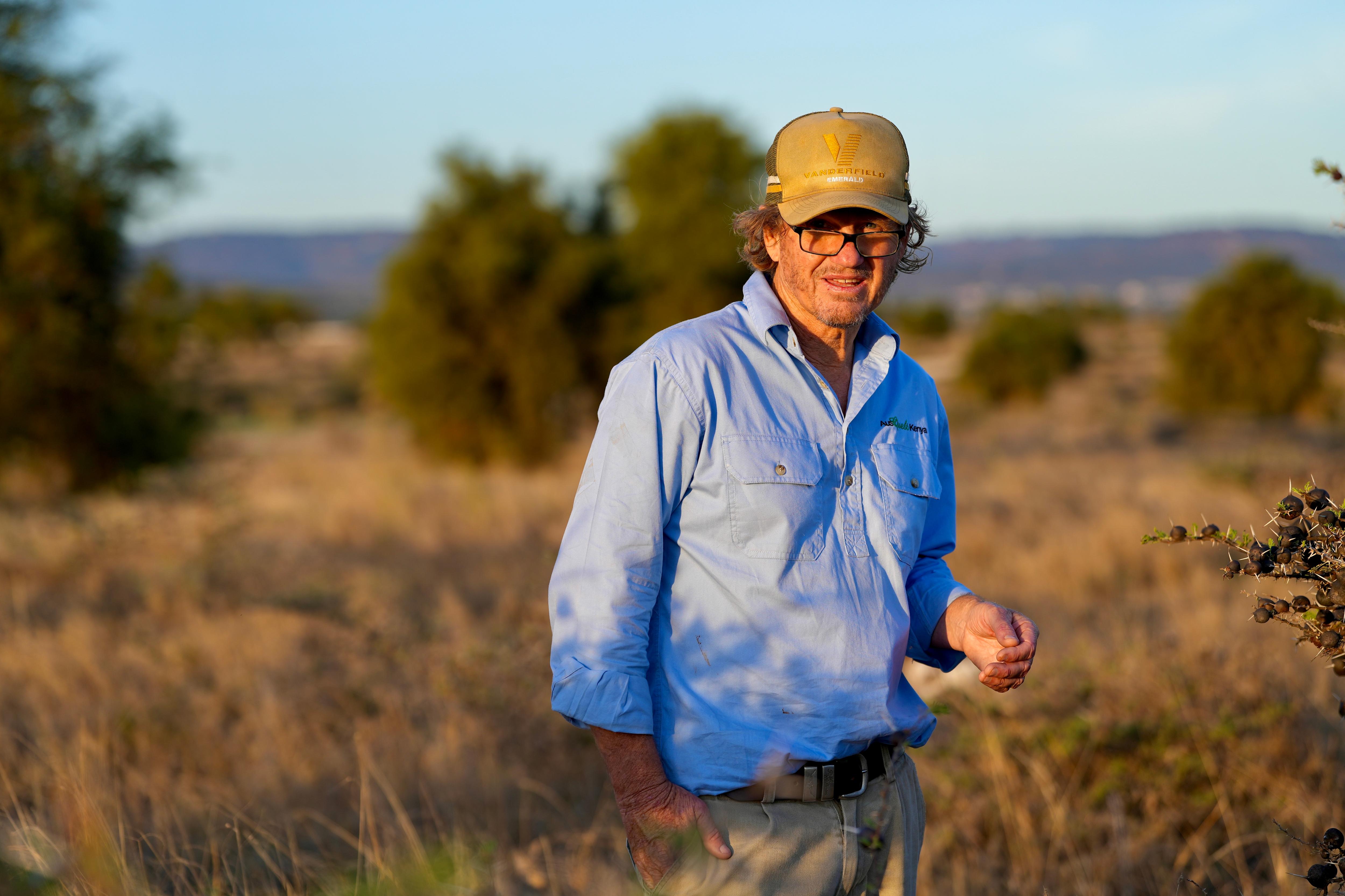 Australian farmer Stuart Barden standing on top of a former hyena's den in Kenya