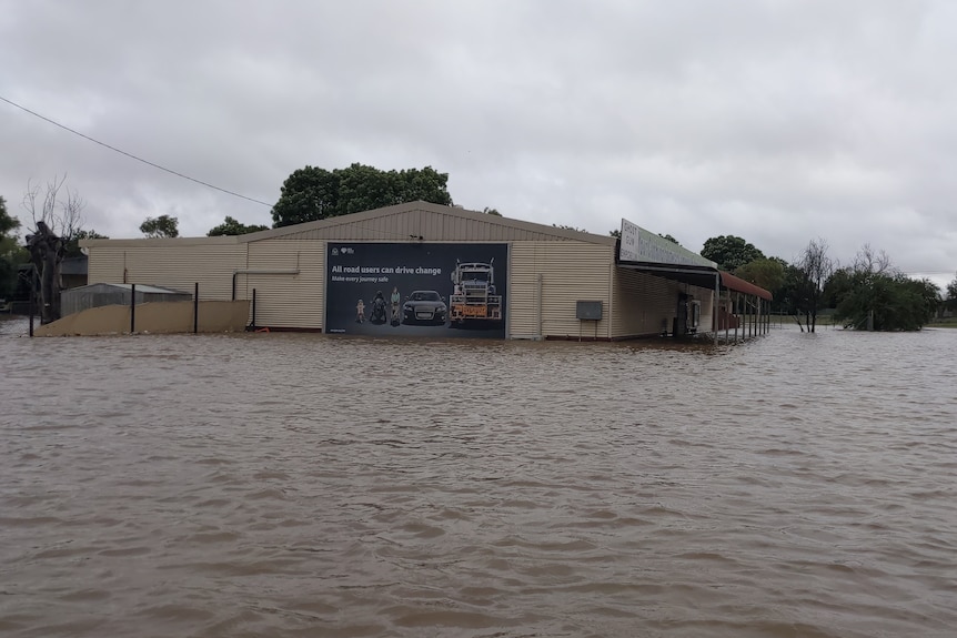 Floodwaters surround a building.