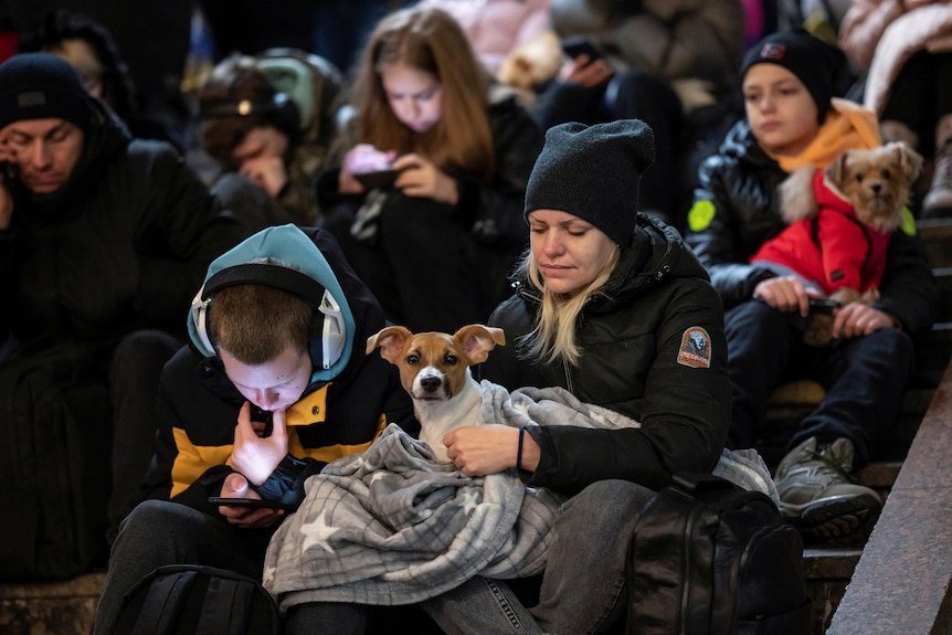 People take shelter inside a metro station.