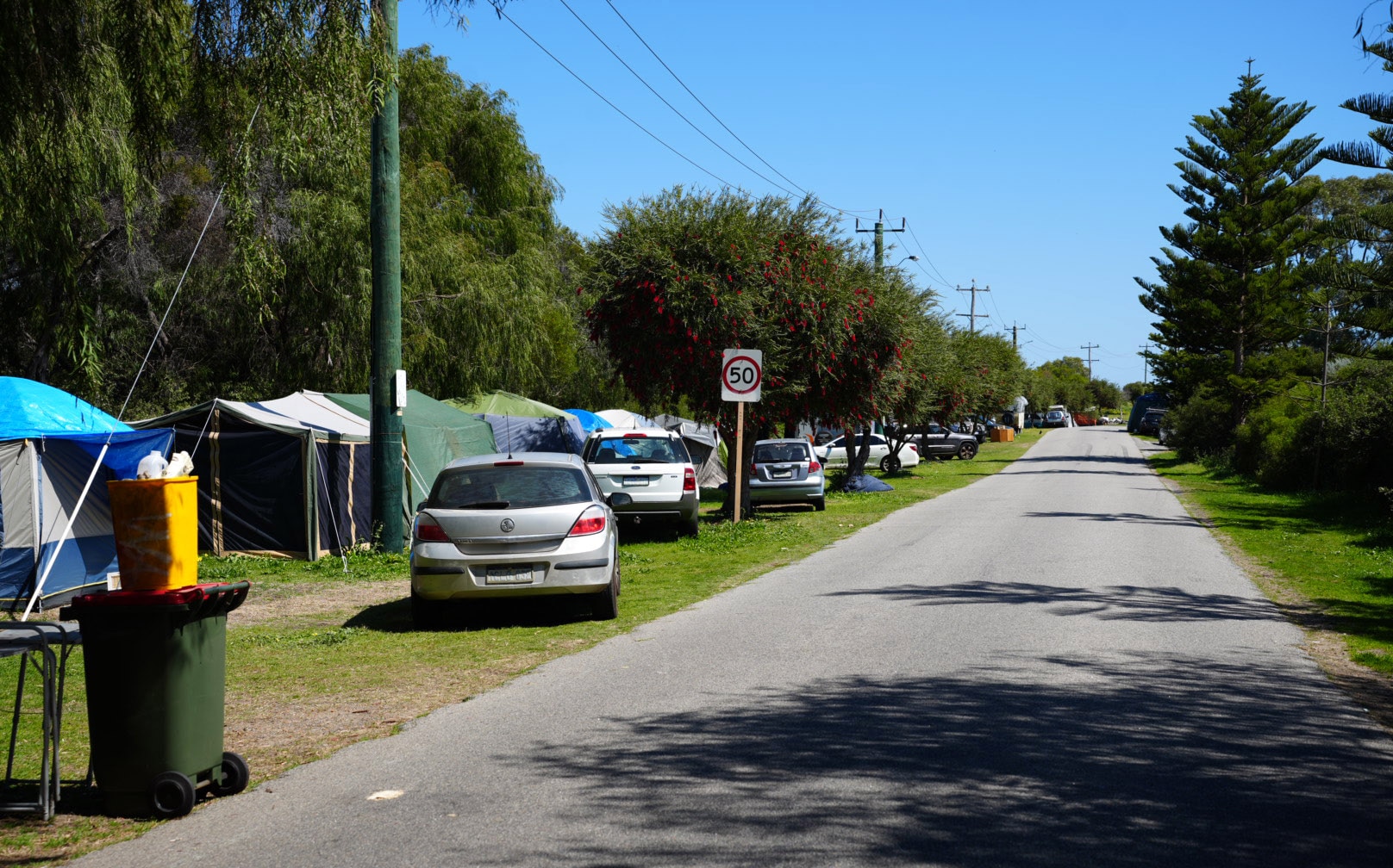 A road with people camped along it