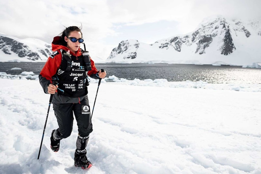 Athlete running through ice in a marathon in Antarctica.