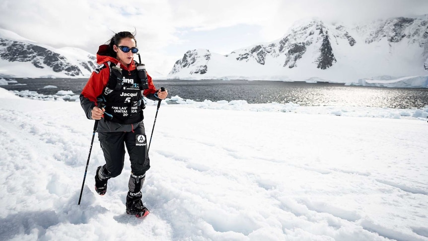 Athlete running through ice in a marathon in Antarctica.
