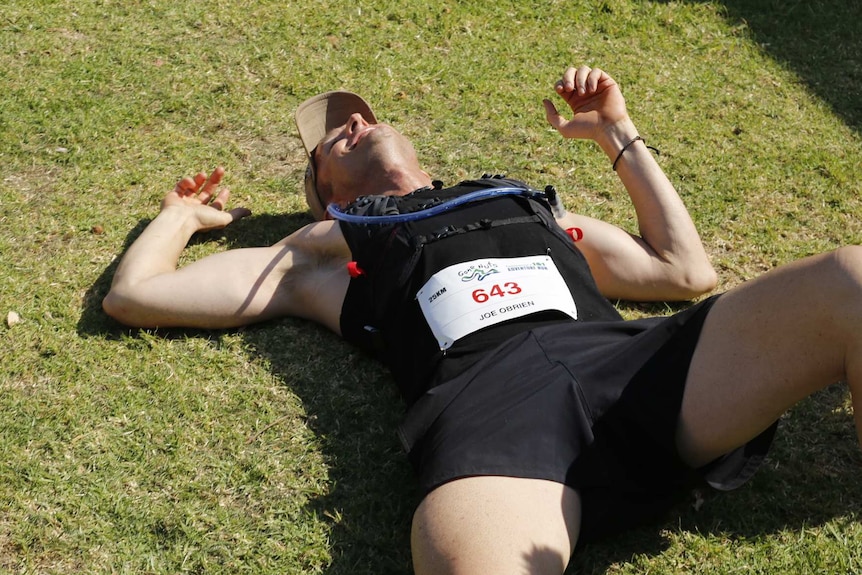 O'Brien lying on ground after completing race.