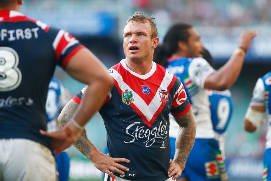 Jake Friend standing with his hands on his hips for the Roosters.