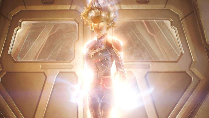 Captain Marvel flying and glowing with power.